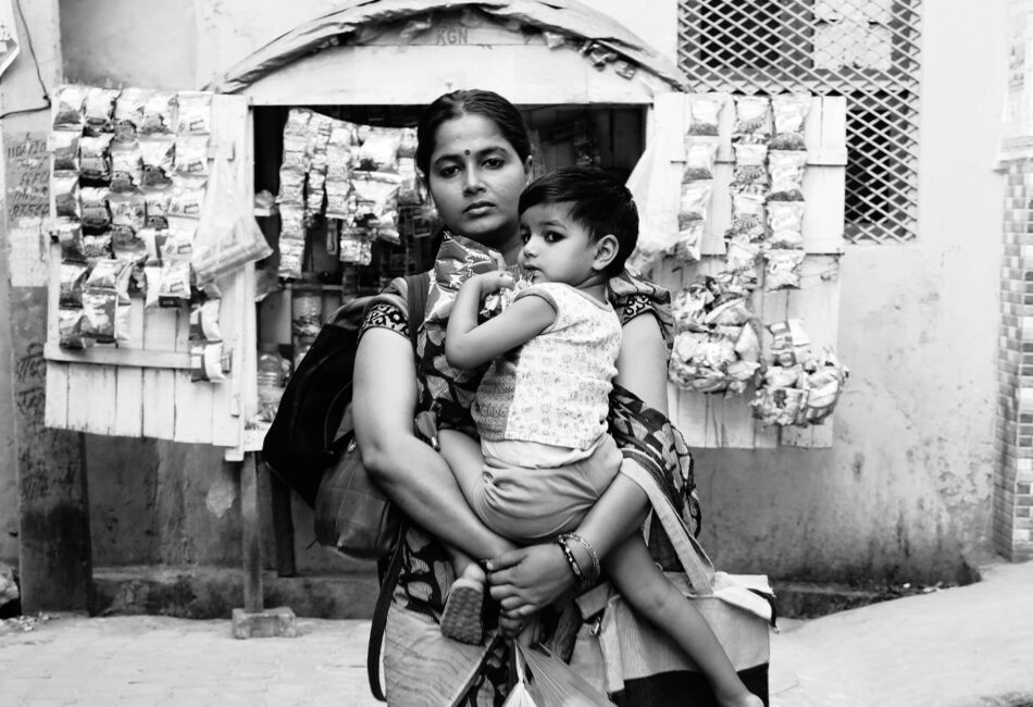 Woman carrying child and shopping bags